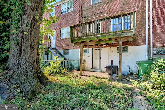 4707 Wrenwood Ave, Baltimore, MD 21212 - rear view of house with brick siding, stairs, and fence