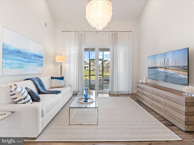 24239 Canoe Dr Unit 204, Millsboro, DE 19966 - living room with wood finished floors, a chandelier, and baseboards