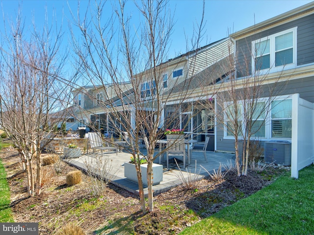 24239 Canoe Dr Unit 204, Millsboro, DE 19966 - rear view of property with central AC unit and a patio