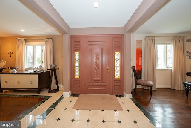foyer featuring recessed lighting, plenty of natural light, baseboards, and tile patterned flooring