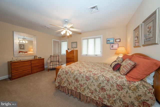 bedroom featuring carpet flooring, visible vents, baseboards, and ceiling fan