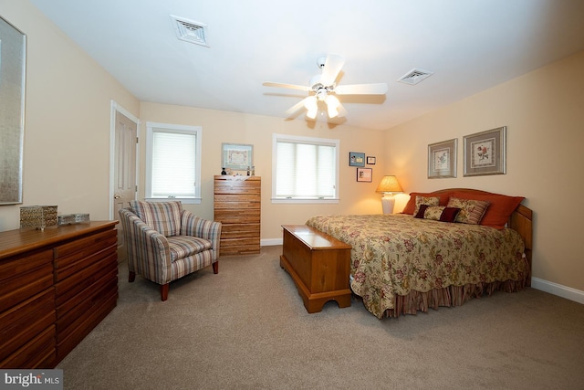bedroom with light colored carpet, baseboards, a ceiling fan, and visible vents
