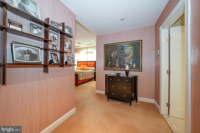 hallway with carpet flooring, baseboards, and wallpapered walls