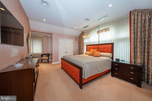 bedroom featuring visible vents, recessed lighting, vaulted ceiling, and light carpet