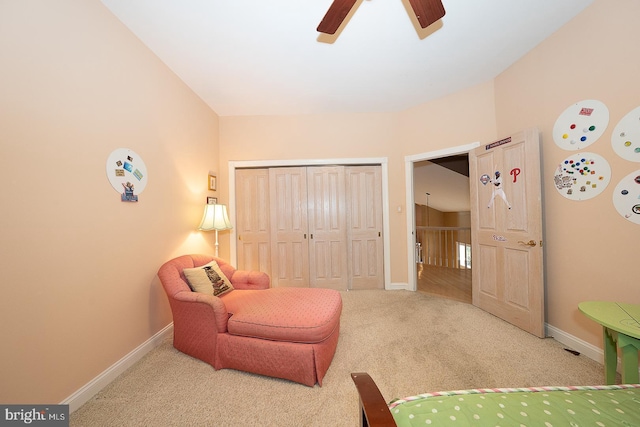 living area featuring ceiling fan, baseboards, and carpet floors