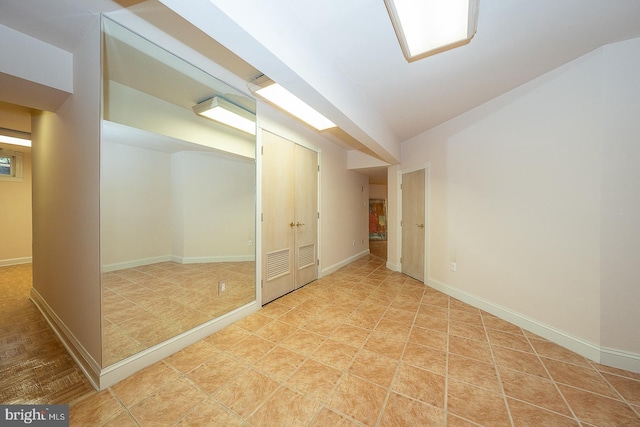 basement featuring visible vents and baseboards