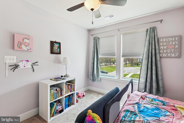 carpeted bedroom with visible vents, baseboards, and ceiling fan