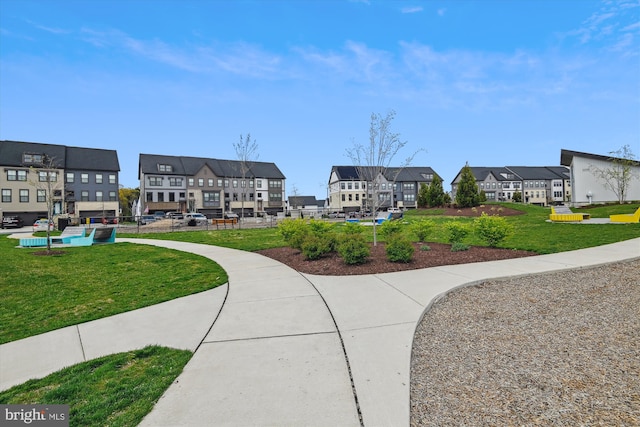 view of home's community featuring a residential view and a lawn
