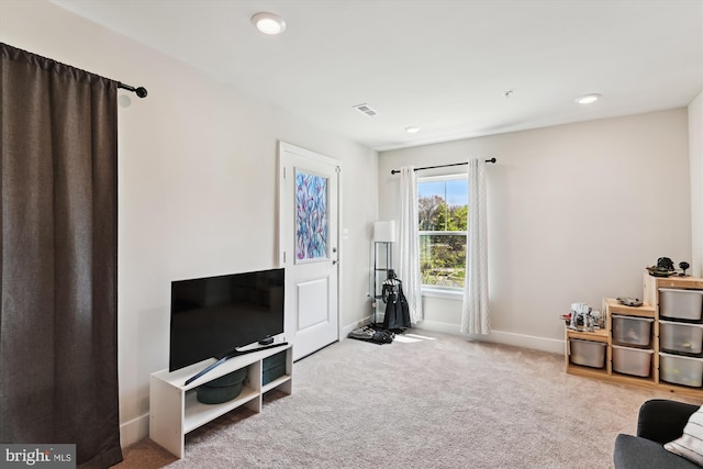living area with recessed lighting, baseboards, visible vents, and carpet floors