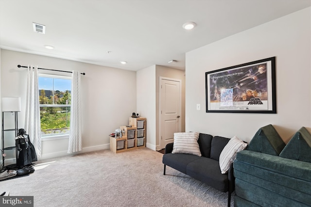 carpeted living area with baseboards, visible vents, and recessed lighting