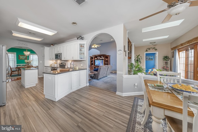 180 Featherbed Ln, Pilesgrove, NJ 08098 - kitchen with stainless steel appliances, dark countertops, arched walkways, and ceiling fan with notable chandelier