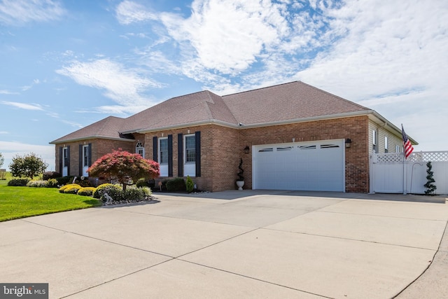 180 Featherbed Ln, Pilesgrove, NJ 08098 - view of front facade with concrete driveway, brick siding, an attached garage, and fence