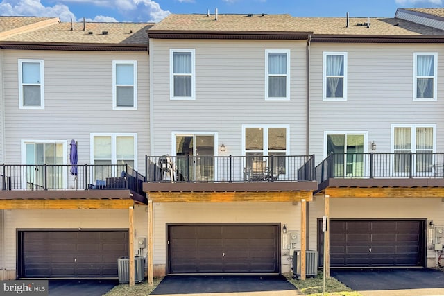 2395 Liberty Loop, Herndon, VA 20171 - back of property with a garage, central AC, and driveway