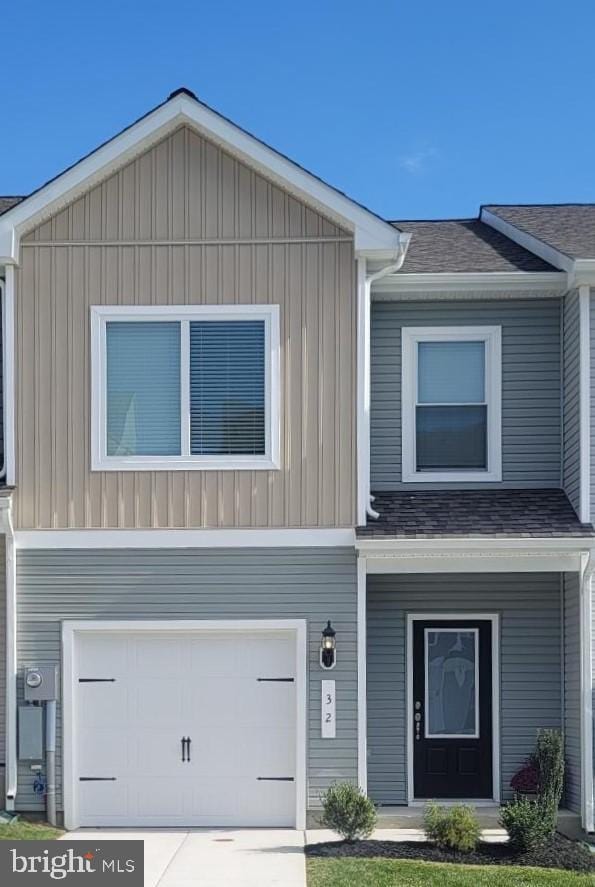 view of front of property with a garage, board and batten siding, and a shingled roof