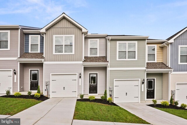 multi unit property featuring board and batten siding and concrete driveway