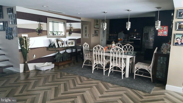 dining room with baseboards and recessed lighting