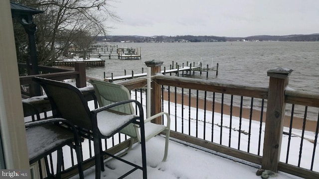 exterior space with a water view and a dock