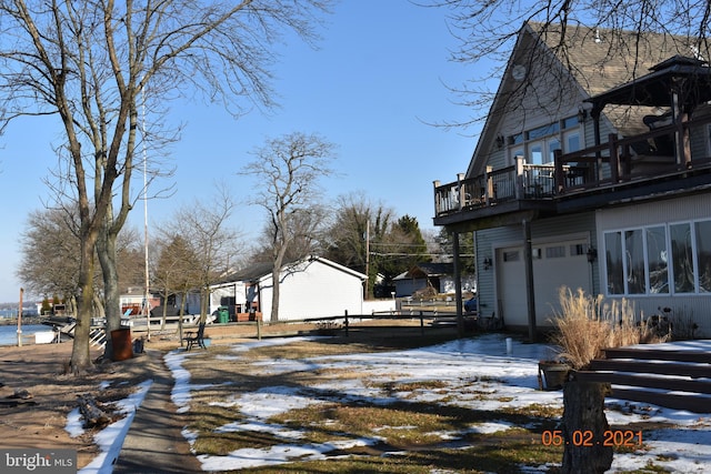 view of snowy exterior featuring a garage