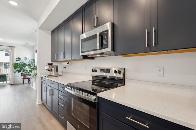 4902 Longmire Way Unit 24, Chantilly, VA 20151 - kitchen with appliances with stainless steel finishes, light wood finished floors, light stone countertops, and recessed lighting