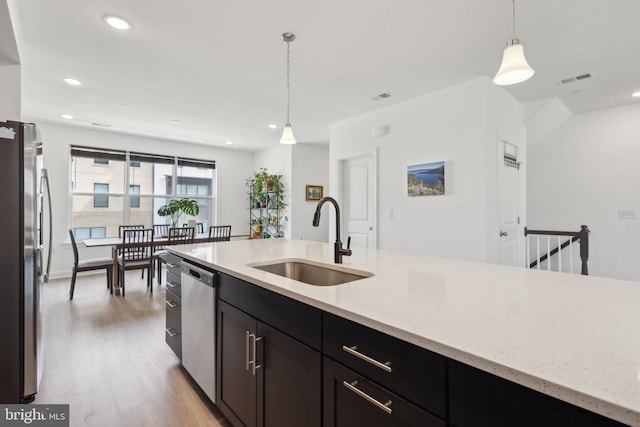 4902 Longmire Way Unit 24, Chantilly, VA 20151 - kitchen with a sink, stainless steel appliances, light wood-type flooring, decorative light fixtures, and light stone countertops