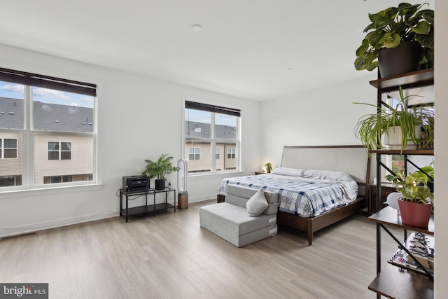 4902 Longmire Way Unit 24, Chantilly, VA 20151 - bedroom with wood finished floors, multiple windows, and baseboards