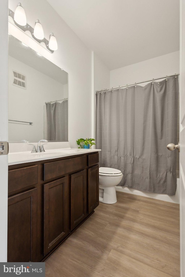 4902 Longmire Way Unit 24, Chantilly, VA 20151 - bathroom featuring wood finished floors, vanity, toilet, and a shower with shower curtain