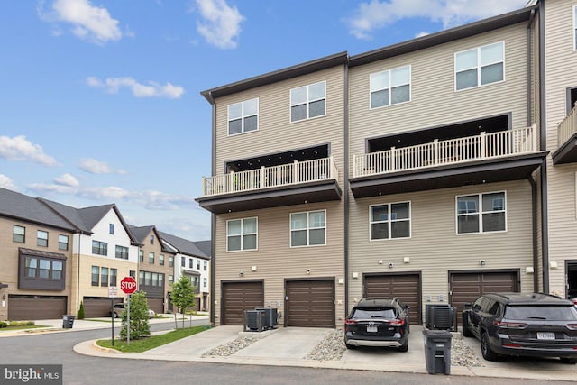 4902 Longmire Way Unit 24, Chantilly, VA 20151 - back of property featuring a residential view, an attached garage, driveway, and central air condition unit