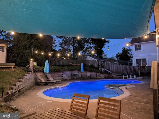 7306 Wayne Dr, Annandale, VA 22003 - pool at twilight featuring a fenced backyard, a pool with connected hot tub, and a patio area