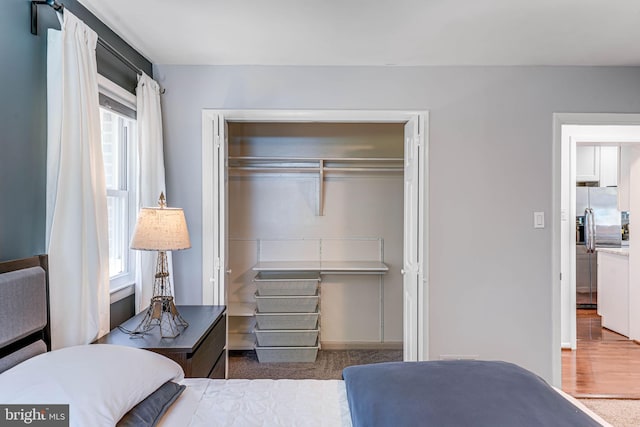 7306 Wayne Dr, Annandale, VA 22003 - bedroom featuring multiple windows, a closet, and stainless steel refrigerator with ice dispenser