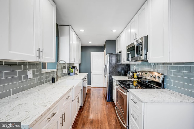 7306 Wayne Dr, Annandale, VA 22003 - kitchen with a sink, appliances with stainless steel finishes, tasteful backsplash, and dark wood-type flooring