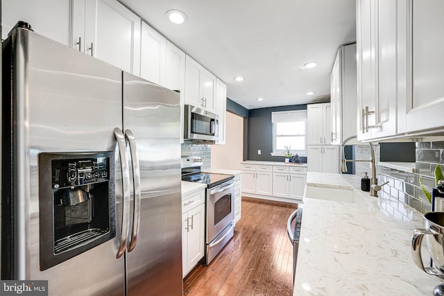 7306 Wayne Dr, Annandale, VA 22003 - kitchen with stainless steel appliances, recessed lighting, white cabinetry, and a sink
