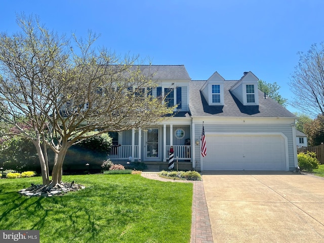 view of front of house with roof with shingles, an attached garage, a front yard, concrete driveway, and covered porch