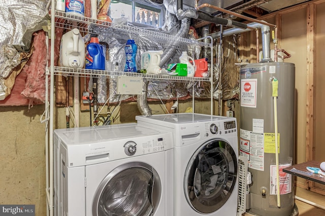 washroom with washer and clothes dryer and water heater
