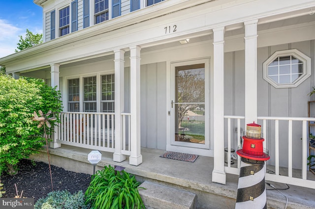 entrance to property featuring a porch and board and batten siding