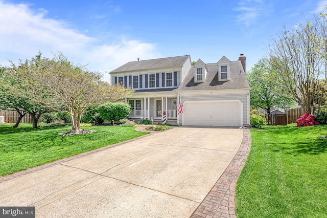 view of front facade featuring an attached garage, a front lawn, fence, and concrete driveway