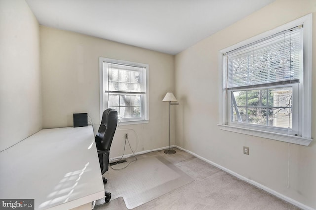 office area featuring baseboards, carpet flooring, and plenty of natural light