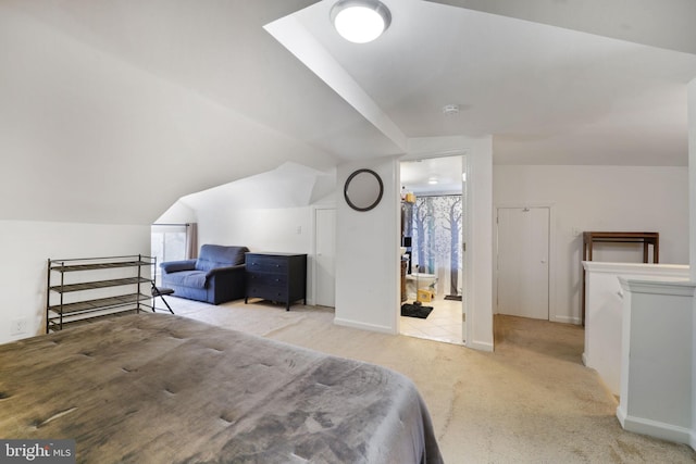 bedroom featuring carpet flooring and lofted ceiling