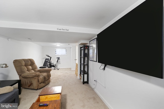 living area featuring light carpet, visible vents, and baseboards