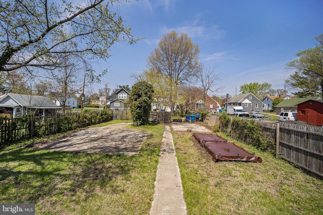 view of yard featuring fence and a residential view