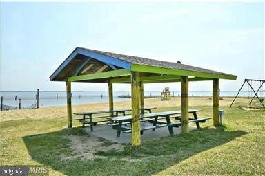 view of community with a lawn, a gazebo, and a water view
