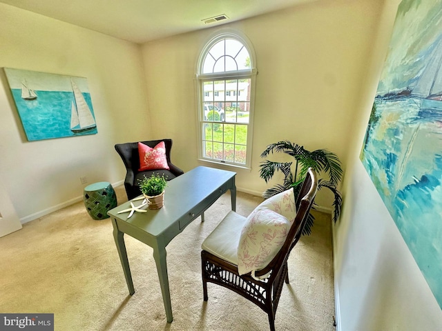living area featuring carpet floors, visible vents, and baseboards