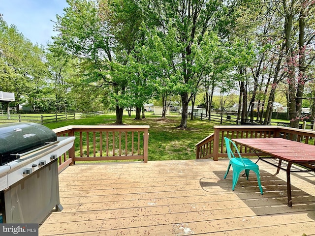wooden deck with grilling area, a yard, outdoor dining space, and fence