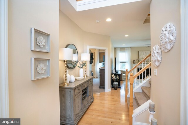 entrance foyer with recessed lighting, light wood-type flooring, and stairs