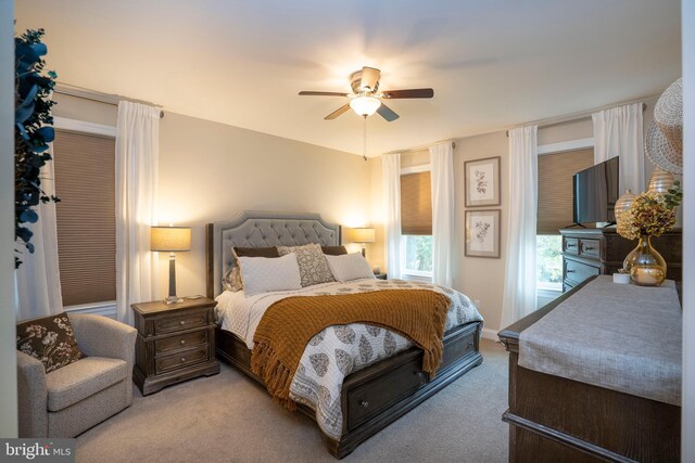 bedroom with light colored carpet and ceiling fan