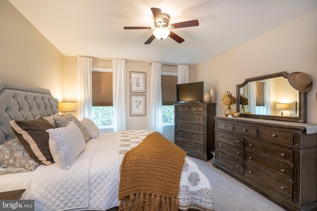 bedroom featuring a ceiling fan and light colored carpet