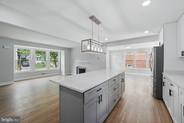 505 N Naylor St, Alexandria, VA 22304 - kitchen with freestanding refrigerator, open floor plan, gray cabinetry, a kitchen island, and light countertops