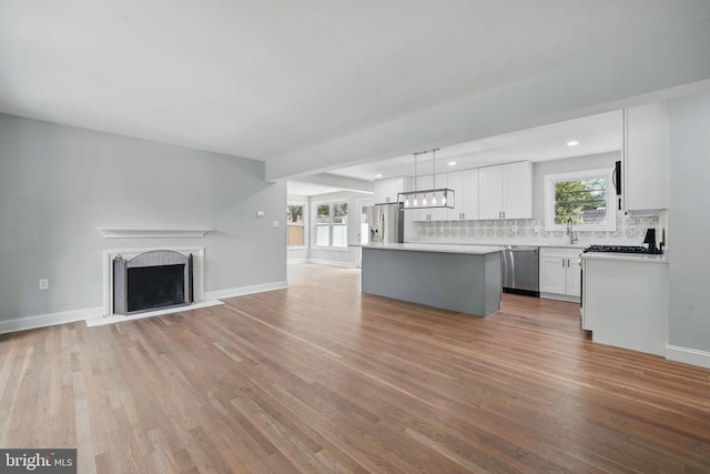 505 N Naylor St, Alexandria, VA 22304 - unfurnished living room featuring a sink, light wood-style flooring, baseboards, a fireplace, and recessed lighting