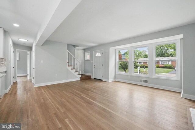 505 N Naylor St, Alexandria, VA 22304 - unfurnished living room featuring stairs, baseboards, light wood-style floors, and recessed lighting