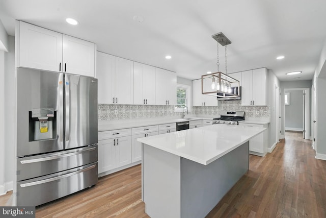 505 N Naylor St, Alexandria, VA 22304 - kitchen featuring stainless steel appliances, backsplash, white cabinetry, light wood-type flooring, and light countertops