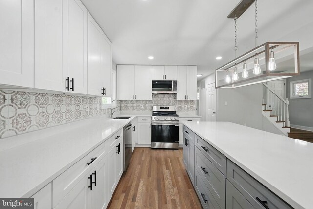 505 N Naylor St, Alexandria, VA 22304 - kitchen with appliances with stainless steel finishes, a sink, gray cabinets, light countertops, and tasteful backsplash